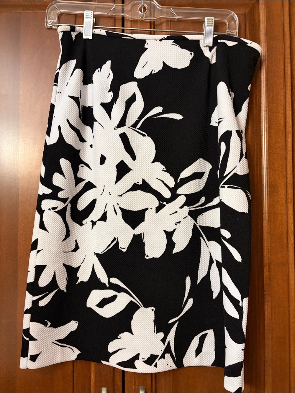 Calvin Klein Black Skirt with White Floral Print size 15” wide by 23” length